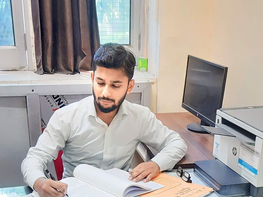 Shivanshu K. Srivastava reading case papers at his desk